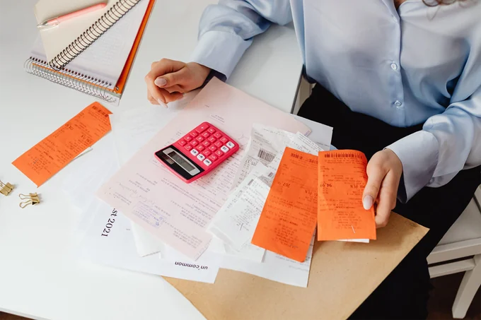 Receipts and printed forms spread across a desk
